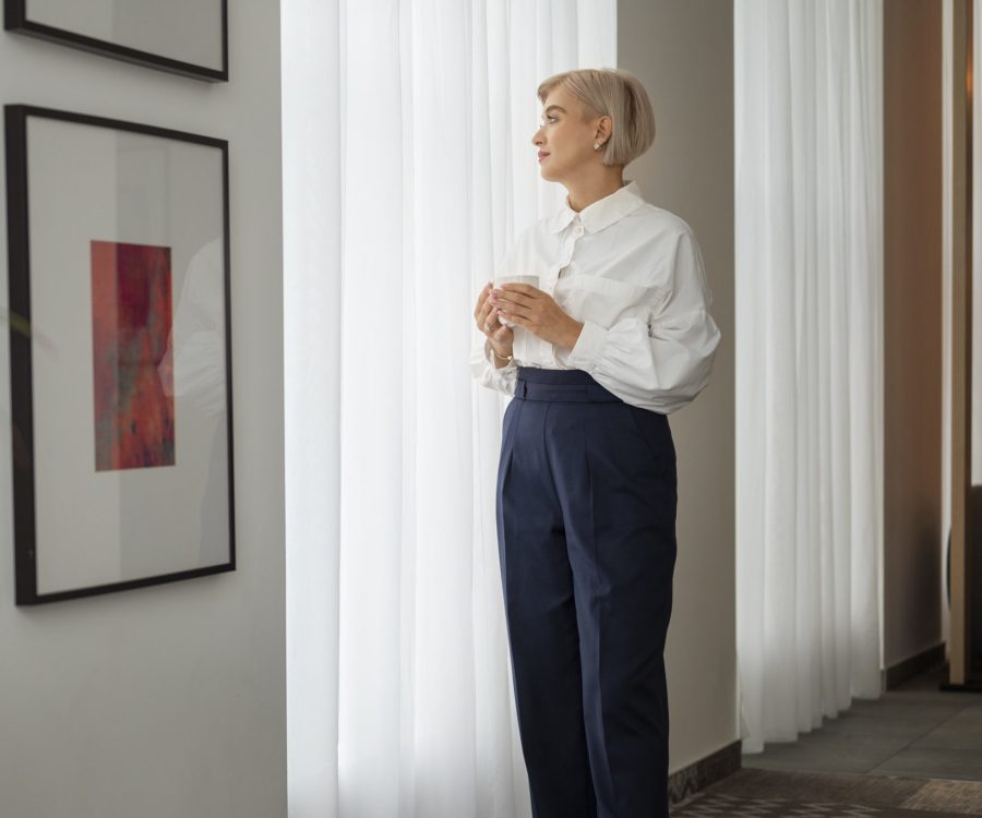 full-shot-woman-looking-out-window